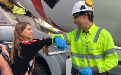 A group of people standing around a plane