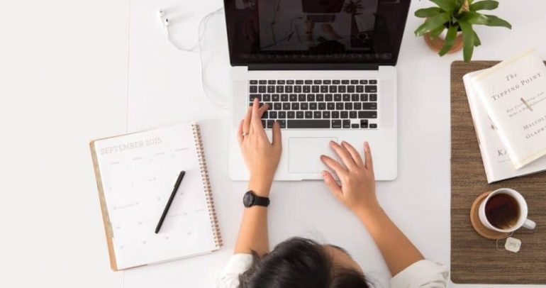 A person working in laptop on table